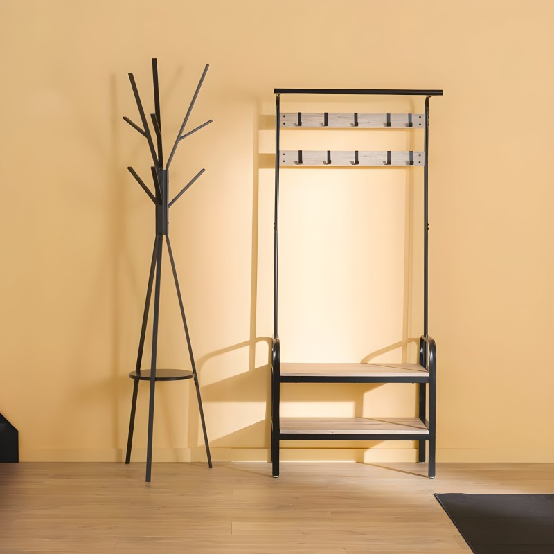 Perchero árbol negro con base circular y espejo de pared con marco negro y madera natural en ambiente