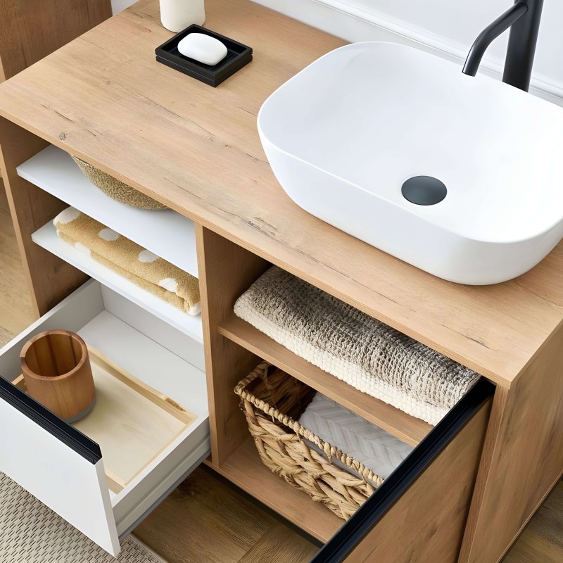 Mueble lavabo de madera clara con cubierta de encimera y lavamanos redondo blanco con grifo negro y almacenamiento abierto para 