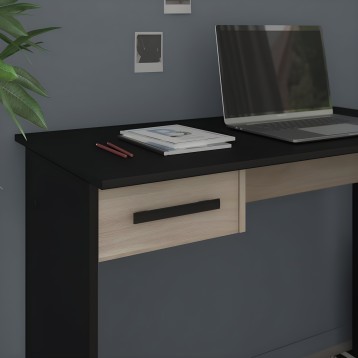 Escritorio con sobre negro y cajón en madera clara en ambiente de oficina con laptop y accesorios