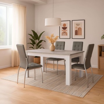 Comedor con mesa rectangular blanca y gris y sillas tapizadas grises con patas metálicas en ambiente luminoso