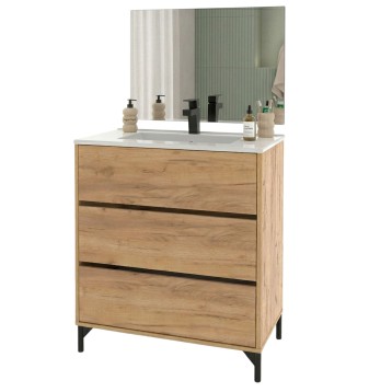 Mueble de baño con madera clara y tres cajones negros encimera blanca y espejo rectangular con marco verde