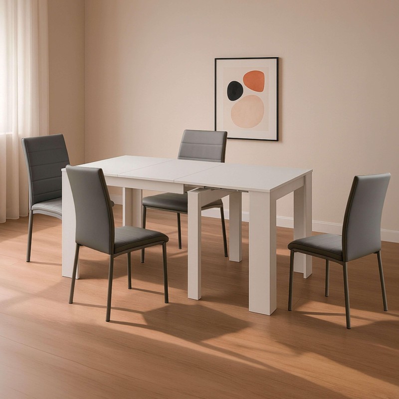 Comedor con mesa extensible blanca y sillas tapizadas en gris y negro en ambiente luminoso