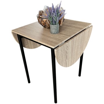 Mesa extensible con tablero en madera clara y patas negras y flores decorativas sobre la superficie