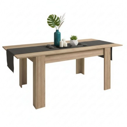 Mesa de comedor rectangular en madera clara con tablero gris oscuro y decoración de plantas y velas