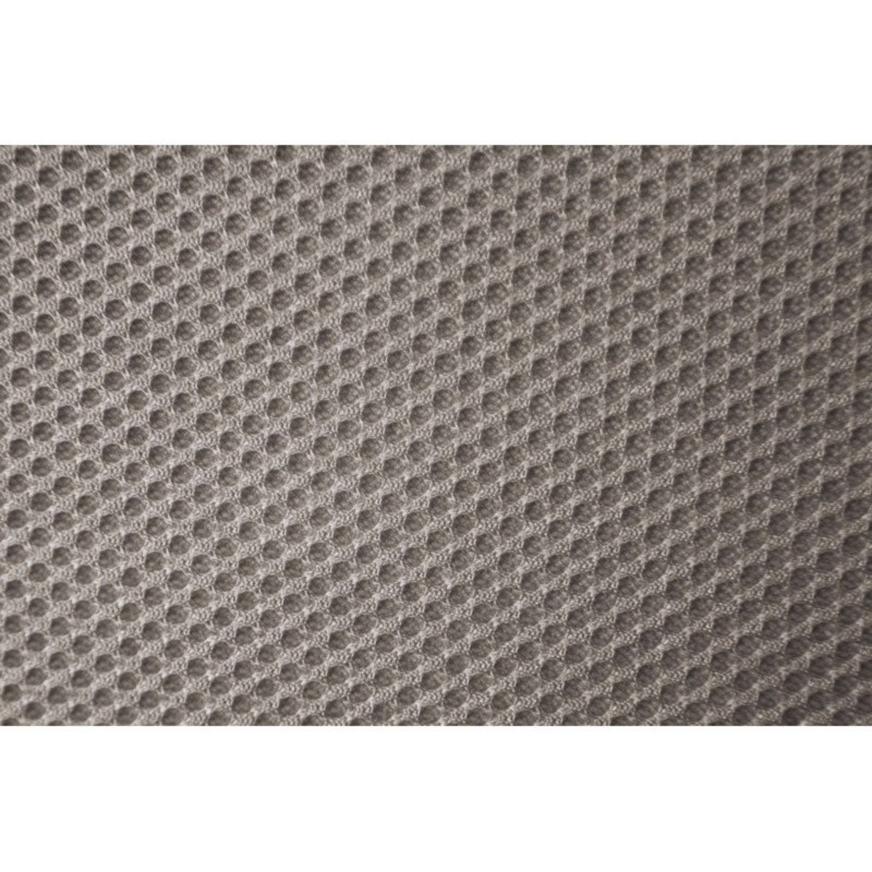 Detalle de tapizado beige con textura de punto y relieve tridimensional