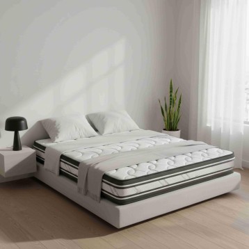Cama tapizada blanca con colchón acolchado gris y negro en ambiente de dormitorio minimalista
