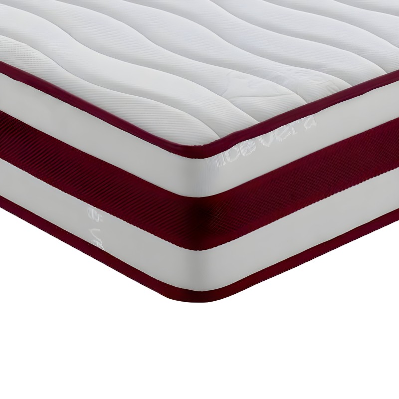 Detalle de colchón con capas visibles en blanco y burdeos mostrando estructura acolchada y base textil