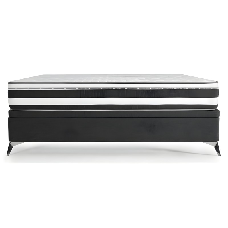 Cama con base tapizada en negro y colchón viscoelástico con capas de espuma y núcleo de muelles
